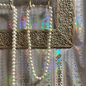 3 beautiful pearl necklaces.